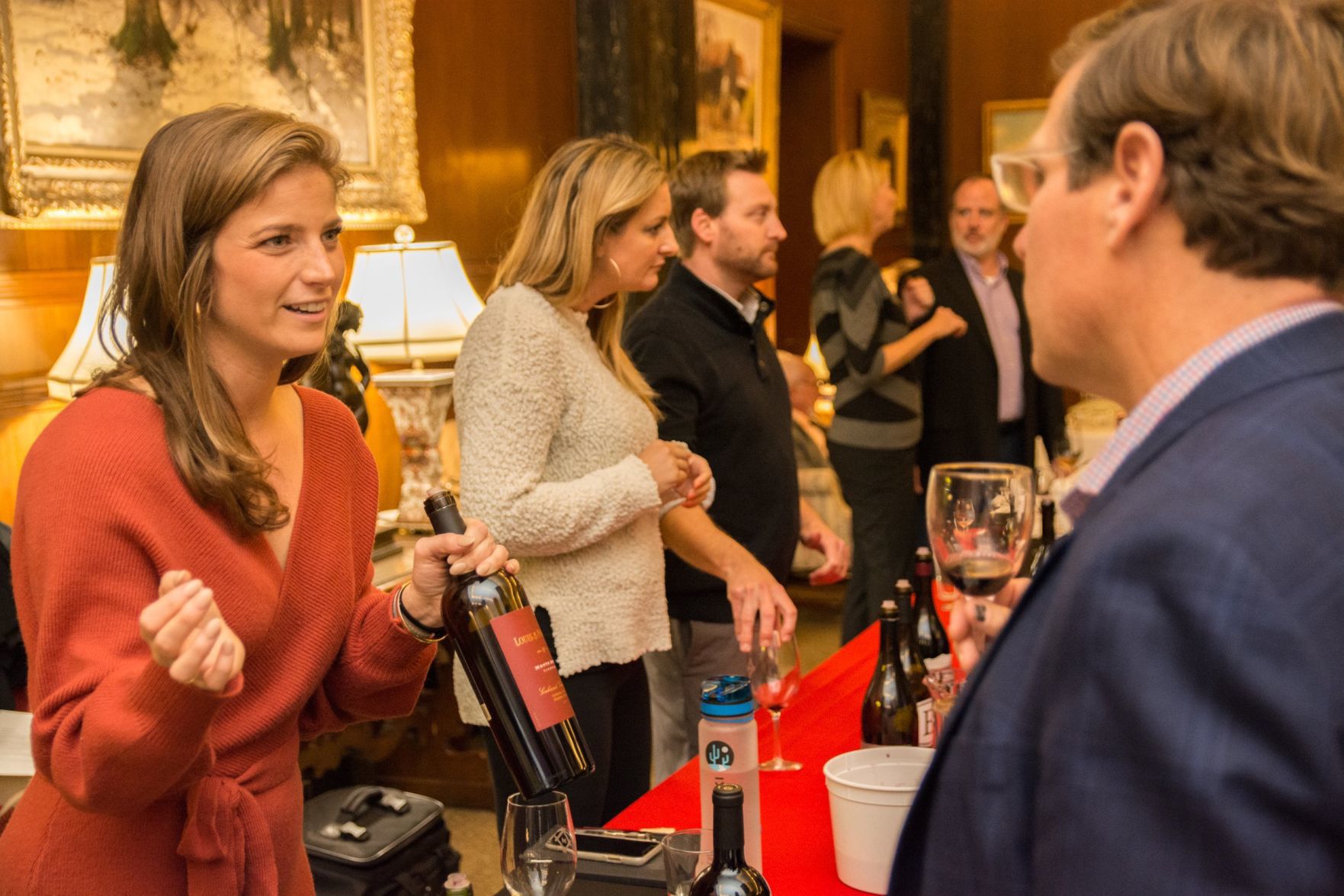 Kenadall Kraus shows a sample of wine